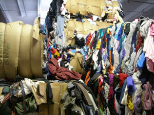 Bales of secondhand clothing are collected in Miami...